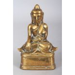 A SMALL 19TH/20TH CENTURY BURMESE POLISHED BRONZE FIGURE OF BUDDHA, seated on a rounded triangular