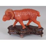 A CHINESE RUSSET HARDSTONE MODEL OF A RAM, together with a fitted wire-inlaid wood stand, 2.25in