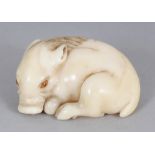 A GOOD QUALITY SIGNED JAPANESE MEIJI PERIOD IVORY NETSUKE OF A BOAR, with inlaid eyes, the base with