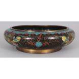 AN EARLY 20TH CENTURY CHINESE SHALLOW CLOISONNE DRAGON BOWL, the base with a Ming mark, 9.7in wide &