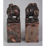 A PAIR OF CHINESE HARDSTONE SEALS, each surmounted by an elephant and boy rider, 3in high.