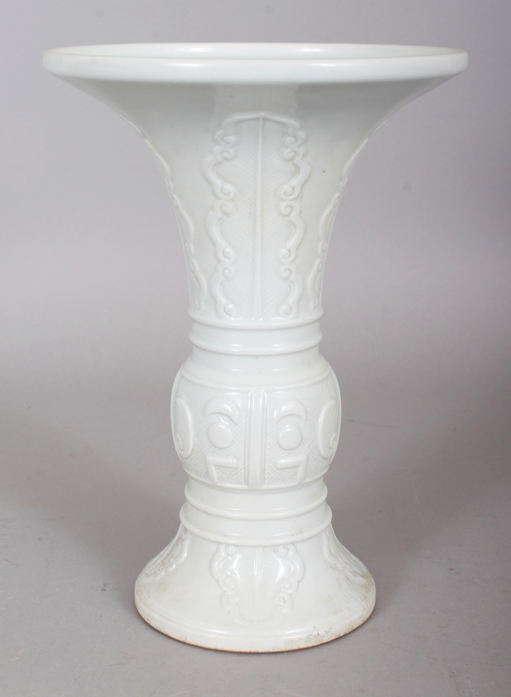 A CHINESE WHITE GLAZED PORCELAIN GU VASE, of archaic bronze design, the base with a Yongzheng seal
