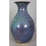 A CHINESE FLAMBE GLAZED PORCELAIN VASE, applied with predominantly blue and purple streaked