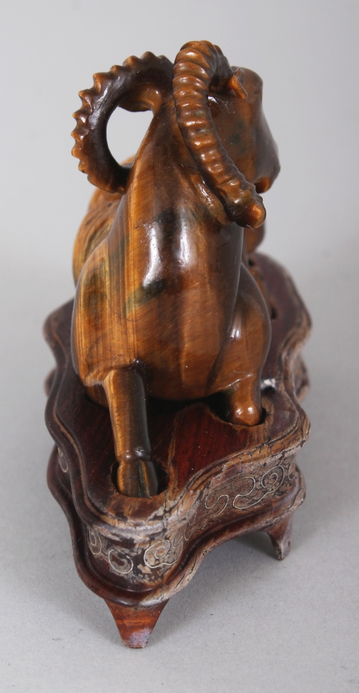 A CHINESE TIGER’S EYE STONE MODEL OF A RAM, together with a fitted wire-inlaid wood stand, 2.75in - Image 2 of 7