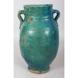A PERSIAN TURQUOISE GLAZED CERAMIC VASE, 19th Century or earlier, the neck with double lug