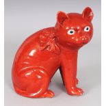 AN UNUSUAL 19TH CENTURY CHINESE IRON-RED GLAZED PORCELAIN MODEL OF A CAT, seated with its head