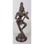 A 20TH CENTURY INDIAN BRONZE FIGURE OF A FEMALE MUSICIAN, standing on a lotus plinth, 11.75in high.