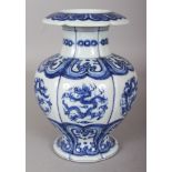 A CHINESE MING STYLE BLUE & WHITE PORCELAIN VASE, the lobed sides decorated with dragon roundels