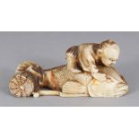 A JAPANESE MEIJI PERIOD CARVED IVORY NETSUKE OF A MAN RIDING A CARP, possibly Ebisu, 1.75in long.