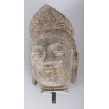 A LARGE CHINESE ARCHAIC STYLE GREY STONE HEAD OF BUDDHA, 12in high.