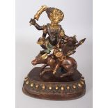 A TIBETAN GILT BRONZE SECTIONAL GROUP OF DHARMAPALA YAMA, the buffalo-headed protector standing on