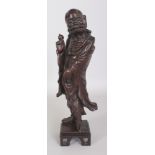 A GOOD QUALITY 19TH CENTURY CHINESE CARVED HARDWOOD FIGURE OF A LOHAN, standing on a fixed square-