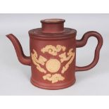 A 19TH CENTURY CHINESE YIXING POTTERY TEAPOT & COVER, decorated in relief with dragons encircling