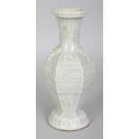 A CHINESE SONG STYLE CELADON GLAZED MOULDED PORCELAIN VASE, the base unglazed, 6.5in high.