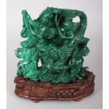 A CHINESE MALACHITE VASE, together with a fitted carved wood stand, the stone elaborately carved and