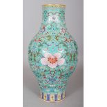 A CHINESE TURQUOISE GROUND FAMILLE ROSE PORCELAIN VASE, decorated with a design of formal