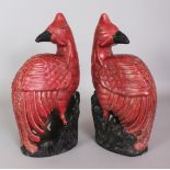 A PAIR OF 20TH CENTURY CHINESE RED GLAZED PORCELAIN PHOENIX, 12.25in high.