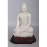 A 19TH CENTURY BURMESE CARVED WHITE MARBLE FIGURE OF BUDDHA, mounted on a fixed wood stand, the