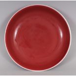 A CHINESE COPPER RED PORCELAIN SAUCER DISH, the glaze thinning to white at the rim, the base with