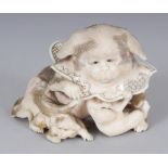 A JAPANESE MEIJI PERIOD IVORY OKIMONO OF A CHIN PEKINESE DOG, in the company of two playful monkeys,