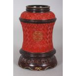 AN UNUSUAL CHINESE IMITATION RED CINNABAR LACQUER PORCELAIN VASE, the sides decorated with gilt Shou