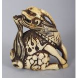 A SIGNED JAPANESE EDO PERIOD IVORY NETSUKE OF A QILIN, the base with an engraved signature, 1.8in