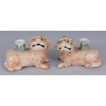 AN UNUSUAL MIRROR PAIR OF 19TH CENTURY PEACH GROUND BUDDHISTIC LION PORCELAIN CANDLESTICKS, their