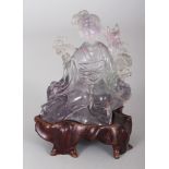 A CHINESE ROCK CRYSTAL CARVING OF A SEATED LADY, together with a fitted wood stand, 4.75in high