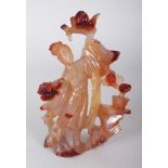 A CHINESE AGATE CARVING OF A STANDING LADY, bearing aloft a bowl of peach, 6in high.