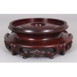 ANOTHER CHINESE CIRCULAR WOOD VASE STAND, with a pierced ruyi and scroll frieze, 7.25in wide at