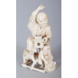 A JAPANESE MEIJI PERIOD IVORY OKIMONO OF AN ANIMATED MAN, quelling two demons, 2.8in high.