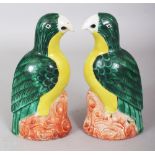 A MIRROR PAIR OF 18TH CENTURY CHINESE PORCELAIN MODELS OF PARROTS, each perched on rockwork with