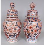 A LARGE PAIR OF GOOD QUALITY 19TH CENTURY JAPANESE IMARI FLUTED PORCELAIN VASES & COVERS, each