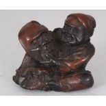 A SMALL JAPANESE CARVED WOOD NETSUKE OF A MASK MAKER, 1.25in wide & also 1.25in high.