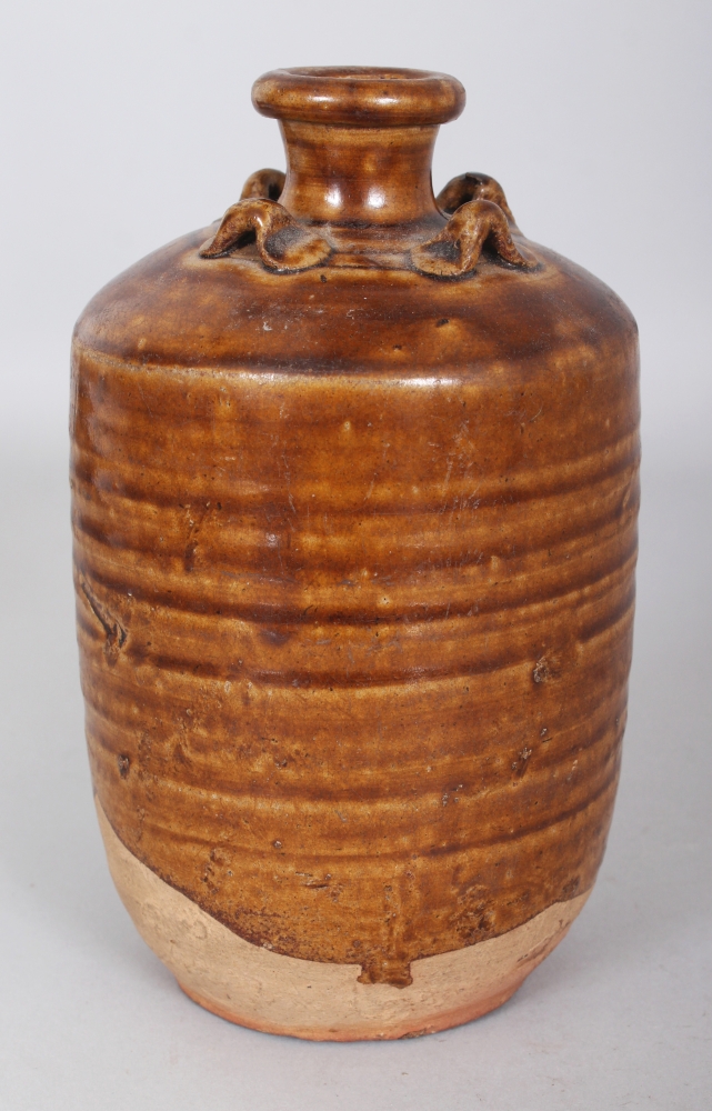 A SOUTH-EAST ASIAN MING DYNASTY BROWN GLAZED POTTERY JAR, possibly Sawankhalok, with four moulded