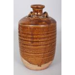 A SOUTH-EAST ASIAN MING DYNASTY BROWN GLAZED POTTERY JAR, possibly Sawankhalok, with four moulded