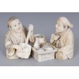 A GOOD QUALITY SIGNED JAPANESE MEIJI PERIOD IVORY OKIMONO OF TWO MEN, seated before a low food laden