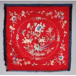 A 19TH/20TH CENTURY CHINESE RED GROUND EMBROIDERED SILK SQUARE FORM PANEL, approx. 29.75in square.