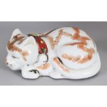 A 20TH CENTURY JAPANESE KUTANI PORCELAIN MODEL OF A SLEEPING CAT, the base unglazed, 7in long & 3.