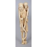 A JAPANESE MEIJI PERIOD MARINE IVORY NETSUKE OF A TALL STANDING MAN, the man’s feet forming the
