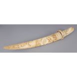 A GOOD JAPANESE MEIJI PERIOD MARINE IVORY TANTO, with a dragon head handle, the sheath carved with