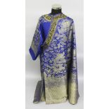 A GOOD QUALITY EARLY 20TH CENTURY CHINESE BLUE GROUND WEAVED SILK DRAGON ROBE, in unused mint