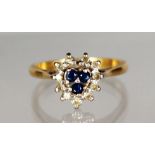 AN 18CT GOLD, DIAMOND AND SAPPHIRE HEART SHAPE CLUSTER RING.