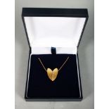 AN 18CT YELLOW GOLD HEART SHAPE PENDANT NECKLACE inset with diamonds.