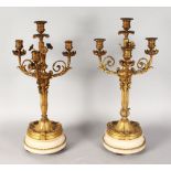 A VERY GOOD PAIR OF LOUIS XVI ORMOLU AND WHITE MARBLE THREE BRANCH CANDELABRA, with flower heads and