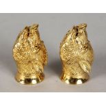 A PAIR OF GOLD PLATED BOARS HEAD SALT AND PEPPERS.