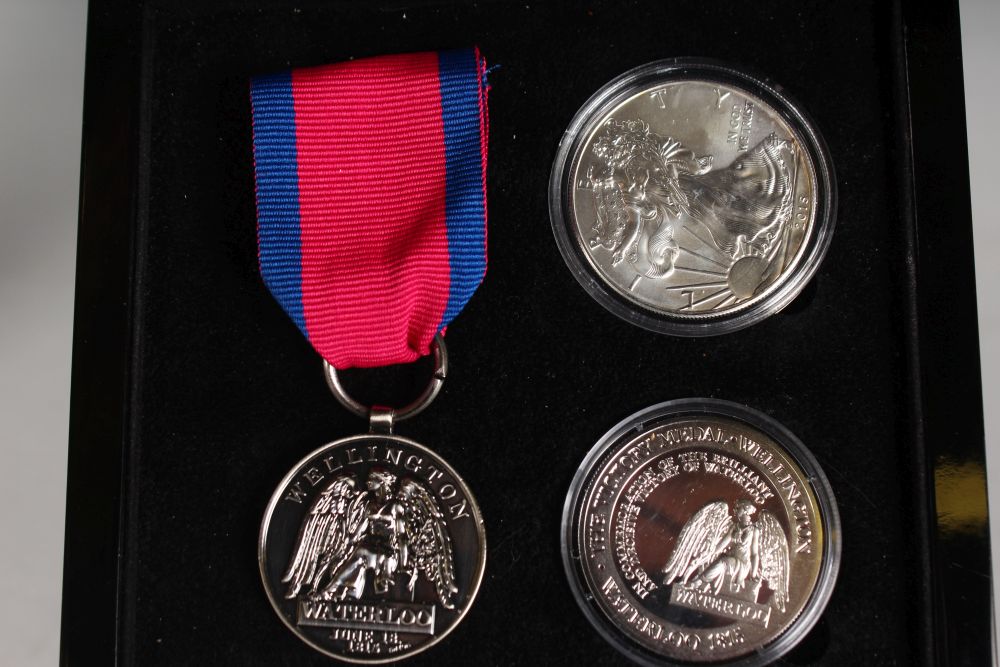 A REPLICA SILVER WATERLOO VICTORY MEDAL AND RIBBON and two silver medals, in a presentation case. - Image 2 of 2