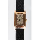 A LADIES GOLD KENDAL & DENT WRISTWATCH with leather strap.