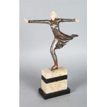 AN ART DECO STYLE GILT BRONZE AND BONE SKATER, on a marble plinth. 14ins high.