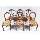 A SET OF SIX VICTORIAN HOOP BACK DINING CHAIRS, with padded serpentine fronted seats, on cabriole